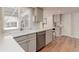 Well-lit kitchen with white cabinetry, stainless steel appliances, and hardwood floors at 8012 S Cedar St, Littleton, CO 80120