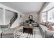 Cozy living room featuring hardwood floors, comfortable seating and a staircase at 8012 S Cedar St, Littleton, CO 80120