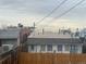 View of the back of the property, showing a flat roof and wooden fence at 3327 Navajo St, Denver, CO 80211