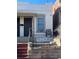 White brick home with a small front porch and wrought iron fence at 3327 Navajo St, Denver, CO 80211