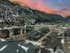 Expansive aerial view of townhomes nestled in a mountain valley with a river and stunning scenery at 2115 Hummingbird Way # 105, Georgetown, CO 80444
