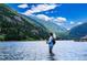 Lake scene with angler, stunning mountain backdrop, serene waters, and lush greenery at 2115 Hummingbird Way # 105, Georgetown, CO 80444