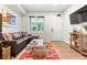 Stylish living room with a modern sofa, colorful rug, and view of snow-covered mountains through the window at 2115 Hummingbird Way # 105, Georgetown, CO 80444