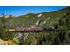 Scenic train view with an antique engine on a trestle surrounded by mountain views and forests at 2115 Hummingbird Way # 105, Georgetown, CO 80444