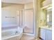 Bathroom with shower, tub and single sink at 9711 Millstone Ct, Highlands Ranch, CO 80130