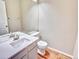 A powder bathroom features a modern sink, a large mirror, and laminate floors at 9711 Millstone Ct, Highlands Ranch, CO 80130