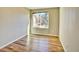 This bedroom features hardwood floors, a large window, and ample natural light at 9711 Millstone Ct, Highlands Ranch, CO 80130