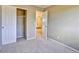 A carpeted bedroom features a walk-in closet and open access to a hallway at 9711 Millstone Ct, Highlands Ranch, CO 80130