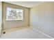 A carpeted bedroom features a large window bringing in ample light at 9711 Millstone Ct, Highlands Ranch, CO 80130