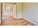 A cozy bedroom with hardwood floors is seen with a view into an open stairway at 9711 Millstone Ct, Highlands Ranch, CO 80130