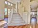 Bright entryway with staircase and view of kitchen at 9711 Millstone Ct, Highlands Ranch, CO 80130