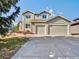 Charming two-story home featuring a stone facade, a large driveway, and an attached two-car garage at 9711 Millstone Ct, Highlands Ranch, CO 80130