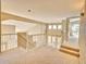 A brightly lit hallway features carpeted floors and has views to the lower level at 9711 Millstone Ct, Highlands Ranch, CO 80130