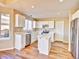 Bright kitchen featuring white cabinetry, modern appliances, and a functional center island at 9711 Millstone Ct, Highlands Ranch, CO 80130