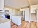 Bright kitchen with white cabinetry, stainless steel appliances, and a central island on wood flooring at 9711 Millstone Ct, Highlands Ranch, CO 80130