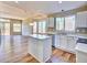 The kitchen features stainless steel appliances, quartz countertops and a large island at 9711 Millstone Ct, Highlands Ranch, CO 80130