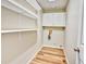 A laundry room features white cabinets, open shelves, laminate floors, and washer/dryer hookups at 9711 Millstone Ct, Highlands Ranch, CO 80130