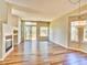 Spacious living room with fireplace, hardwood floors, and sliding glass doors to a deck at 9711 Millstone Ct, Highlands Ranch, CO 80130