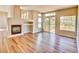 Spacious living room featuring a fireplace, large windows, and a sliding door to the deck at 9711 Millstone Ct, Highlands Ranch, CO 80130