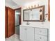 Bathroom boasts an open doorway, and a large mirror over a white vanity at 1101 E 7Th Avenue Cir, Broomfield, CO 80020