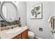 Stylish powder room features a mosaic backsplash, vanity, and decorative painting at 1101 E 7Th Avenue Cir, Broomfield, CO 80020