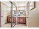 Double vanity bathroom features a large mirror, wood cabinets, and plenty of space at 1101 E 7Th Avenue Cir, Broomfield, CO 80020