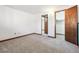 An empty carpeted bedroom with wood trim has two open doorways to other spaces at 1101 E 7Th Avenue Cir, Broomfield, CO 80020