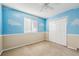 Bedroom with a cloud-themed painted wall, a ceiling fan, and a closet provides a whimsical touch at 1101 E 7Th Avenue Cir, Broomfield, CO 80020