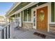 Cozy front porch with seating, decorative lighting, and a wood-framed glass door at 1101 E 7Th Avenue Cir, Broomfield, CO 80020