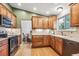 Well-lit kitchen with wood cabinets, stone countertops, and stainless steel appliances at 1101 E 7Th Avenue Cir, Broomfield, CO 80020