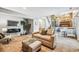 Inviting living room with a cozy tan sofa, ottoman and a view of the dining area at 1101 E 7Th Avenue Cir, Broomfield, CO 80020