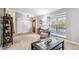 Inviting living room with large windows, neutral colors, and tiled entryway at 1101 E 7Th Avenue Cir, Broomfield, CO 80020