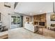 Bright living room with a brick fireplace and sliding doors to the deck at 1101 E 7Th Avenue Cir, Broomfield, CO 80020