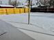 Snowy backyard with wood fence and covered patio at 1244 Racine St, Aurora, CO 80011