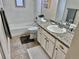 Clean bathroom with a white vanity, tub and shower at 1244 Racine St, Aurora, CO 80011