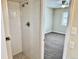 Modern bathroom with a large walk-in shower and grey tile flooring at 1244 Racine St, Aurora, CO 80011