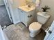 Small bathroom with toilet, vanity, and a small rug at 1244 Racine St, Aurora, CO 80011