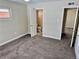 Bedroom with access to a full bathroom and additional doors at 1244 Racine St, Aurora, CO 80011