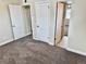 Spacious bedroom with carpet flooring and access to two separate rooms at 1244 Racine St, Aurora, CO 80011