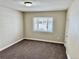 Simple bedroom with a window offering natural light and neutral decor at 1244 Racine St, Aurora, CO 80011