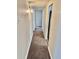 Clean and bright hallway with carpeted floors and neutral walls at 1244 Racine St, Aurora, CO 80011