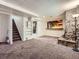 Spacious carpeted basement with shelving and a unique stone fireplace, perfect for entertaining or relaxing at 10736 Logan Ct, Northglenn, CO 80233