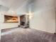 Finished basement with stone fireplace, carpet flooring, and a wet bar at 10736 Logan Ct, Northglenn, CO 80233