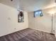 Finished basement area with carpeted floors, bright lighting, and a decorative wall hanging at 10736 Logan Ct, Northglenn, CO 80233