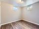 Bedroom with neutral walls, wood-look flooring, and natural light from windows at 10736 Logan Ct, Northglenn, CO 80233