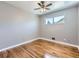Comfortable bedroom with natural light, hardwood floors, and a ceiling fan for added comfort at 10736 Logan Ct, Northglenn, CO 80233