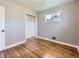 Bright bedroom with hardwood floors, neutral walls, and a closet perfect for storage and organization at 10736 Logan Ct, Northglenn, CO 80233