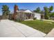 Charming single-story brick home with a well-manicured lawn and two car garage at 10736 Logan Ct, Northglenn, CO 80233