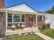 Inviting front porch with chairs, brick facade, and well-maintained landscaping at 10736 Logan Ct, Northglenn, CO 80233