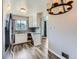 Kitchen featuring neutral color palette, wood floors, white cabinetry and stainless steel appliances at 10736 Logan Ct, Northglenn, CO 80233